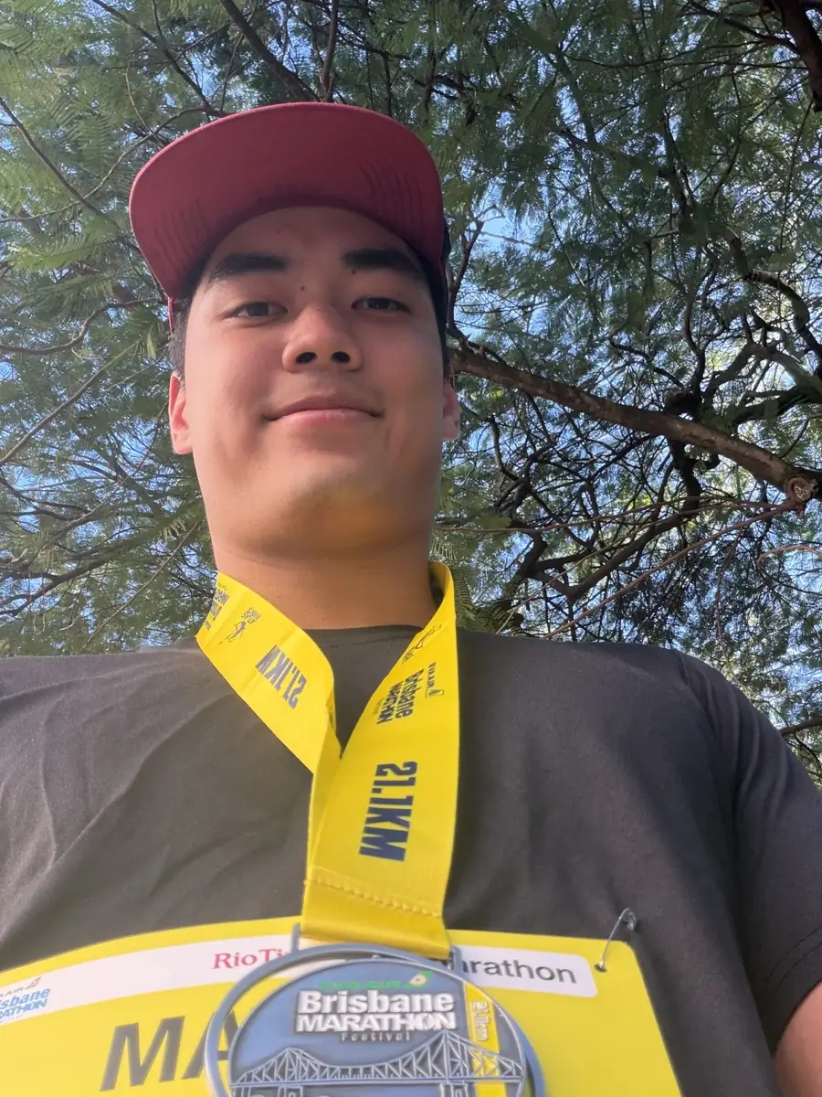 Outdoor selfie wearing a race medal